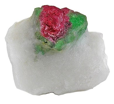 Spinel on top of a pargasite (a complex inosilicate mineral), and both perched and centered atop a marble matrix.